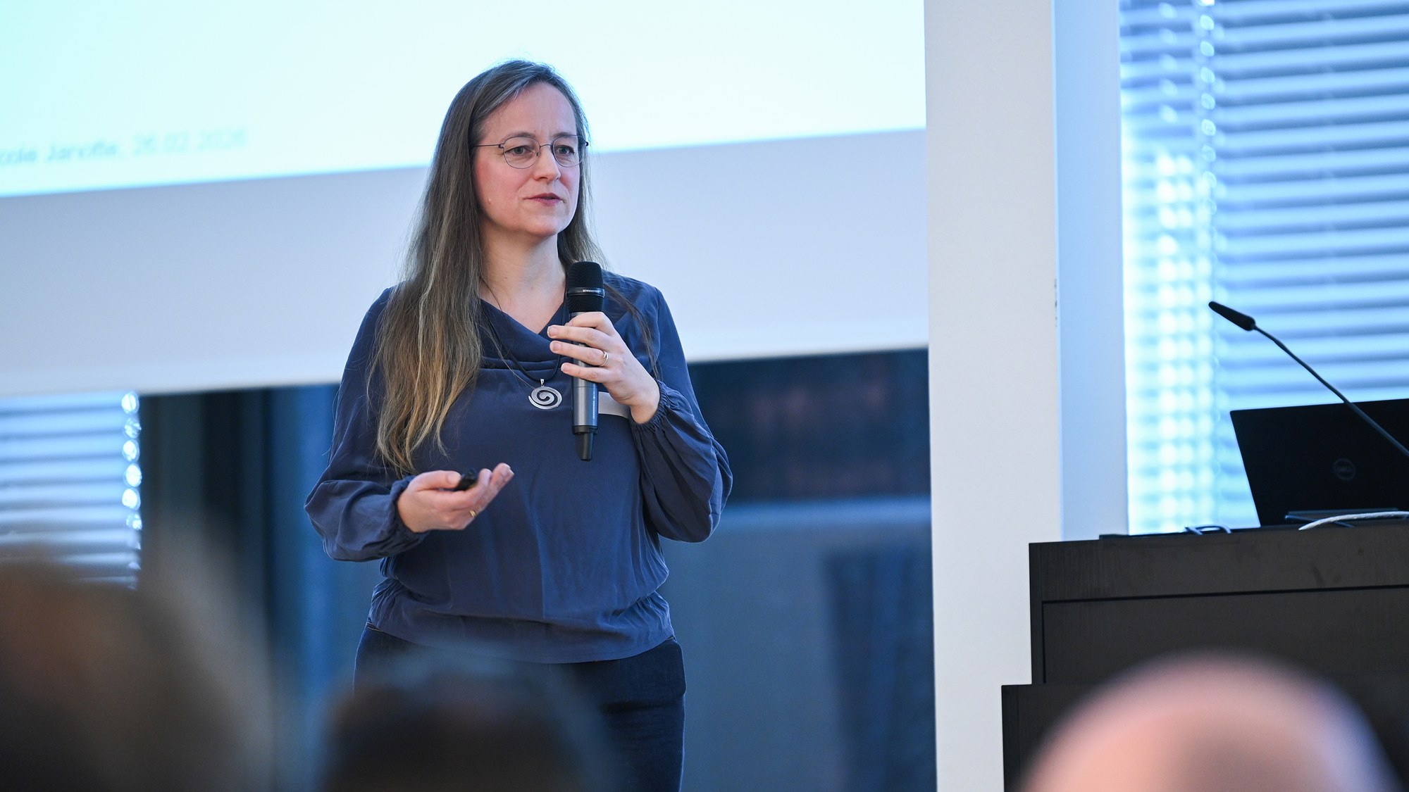 Eine Wissenschaftlerin des Instituts stellt dem Plenum die Abteilung für chemische und physikalische Grundlagen vor.