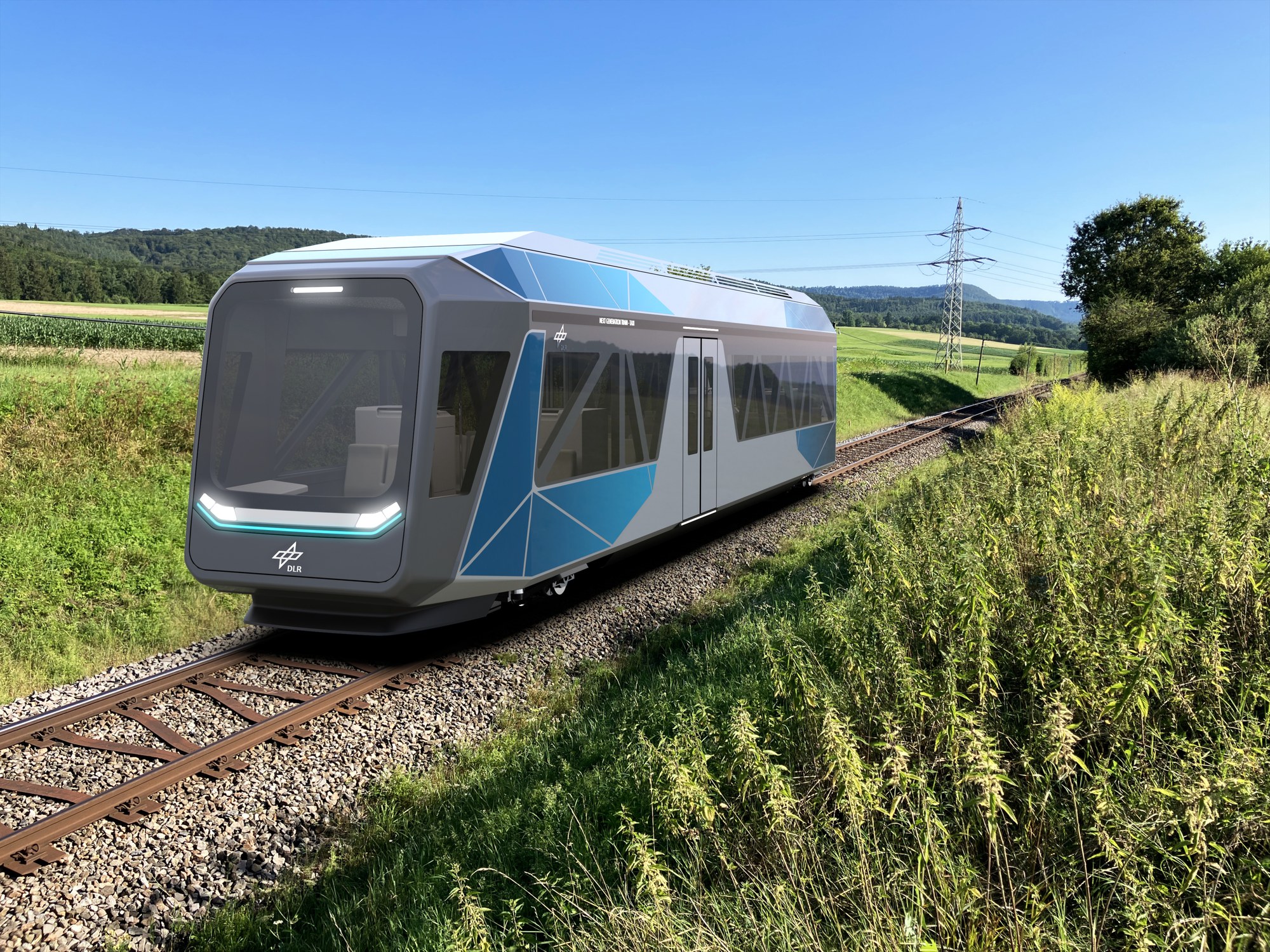 NGT-TAXI fährt auf Schienen an einer Landschaft vorbei