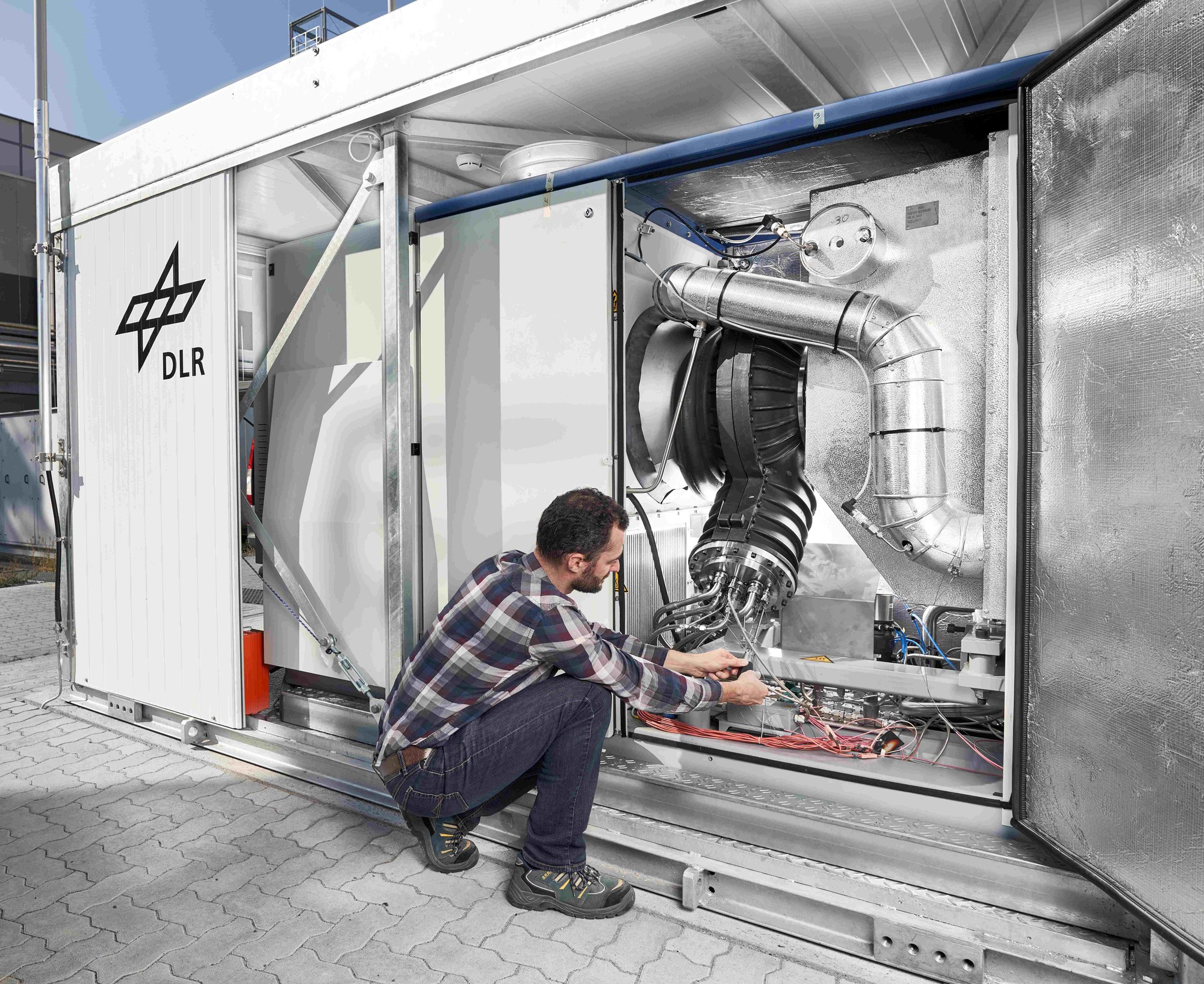 Blick über die Schulter eines Wissenschaftlers ins Innere einer Mikrogasturbine