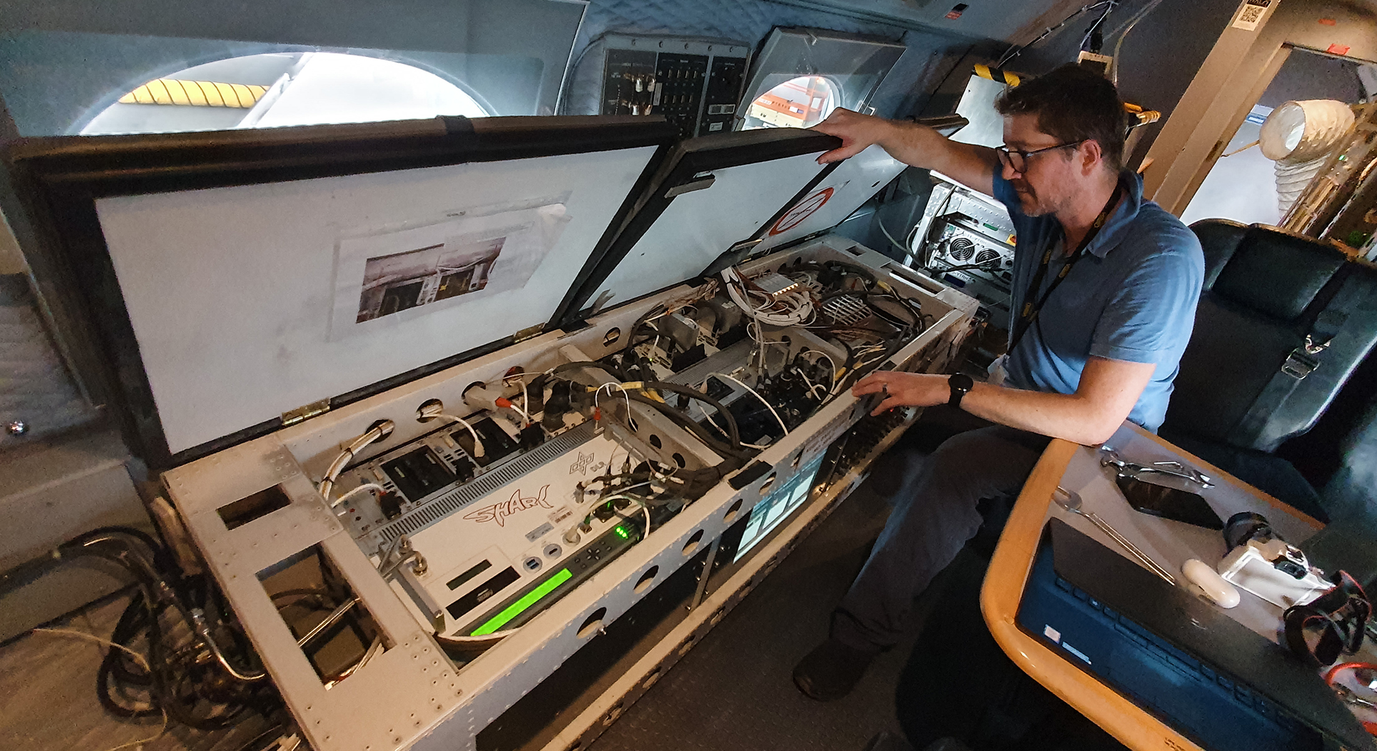 Christian Mallaun prepares the equipment on board for the flight