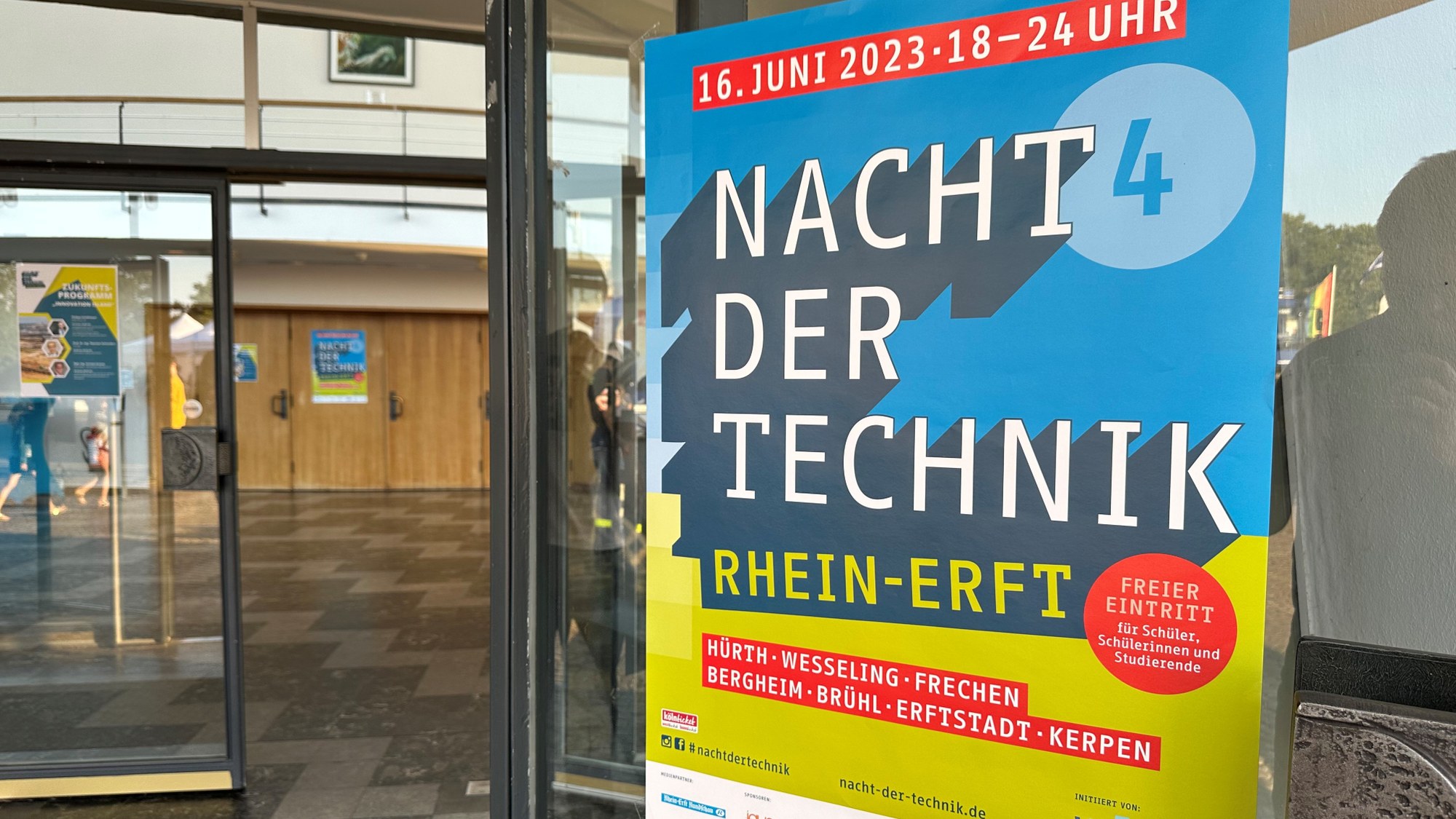 A poster for the Night of Technology 2023 hangs at the entrance to the Feierabendhaus Knapsack.