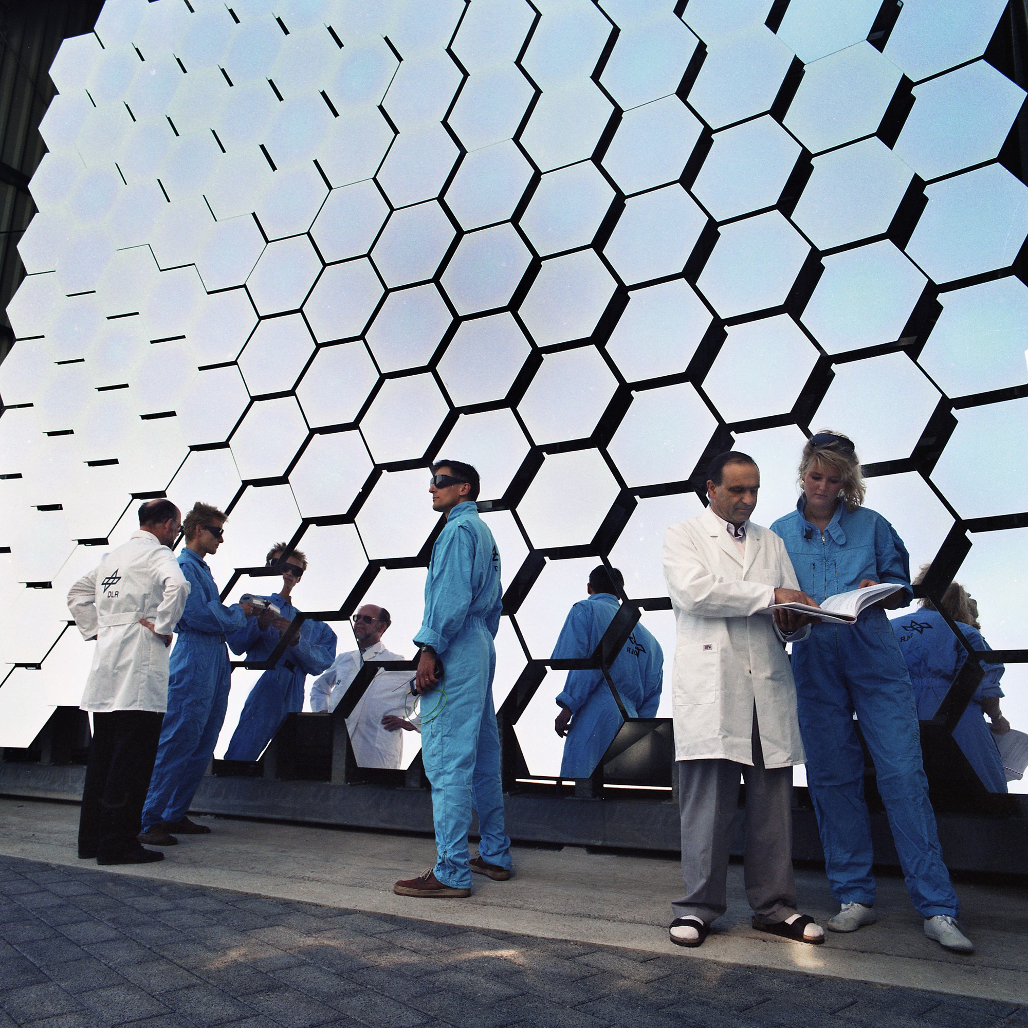 DLR employees in front of the concentrator of the solar furnace in Cologne-Porz