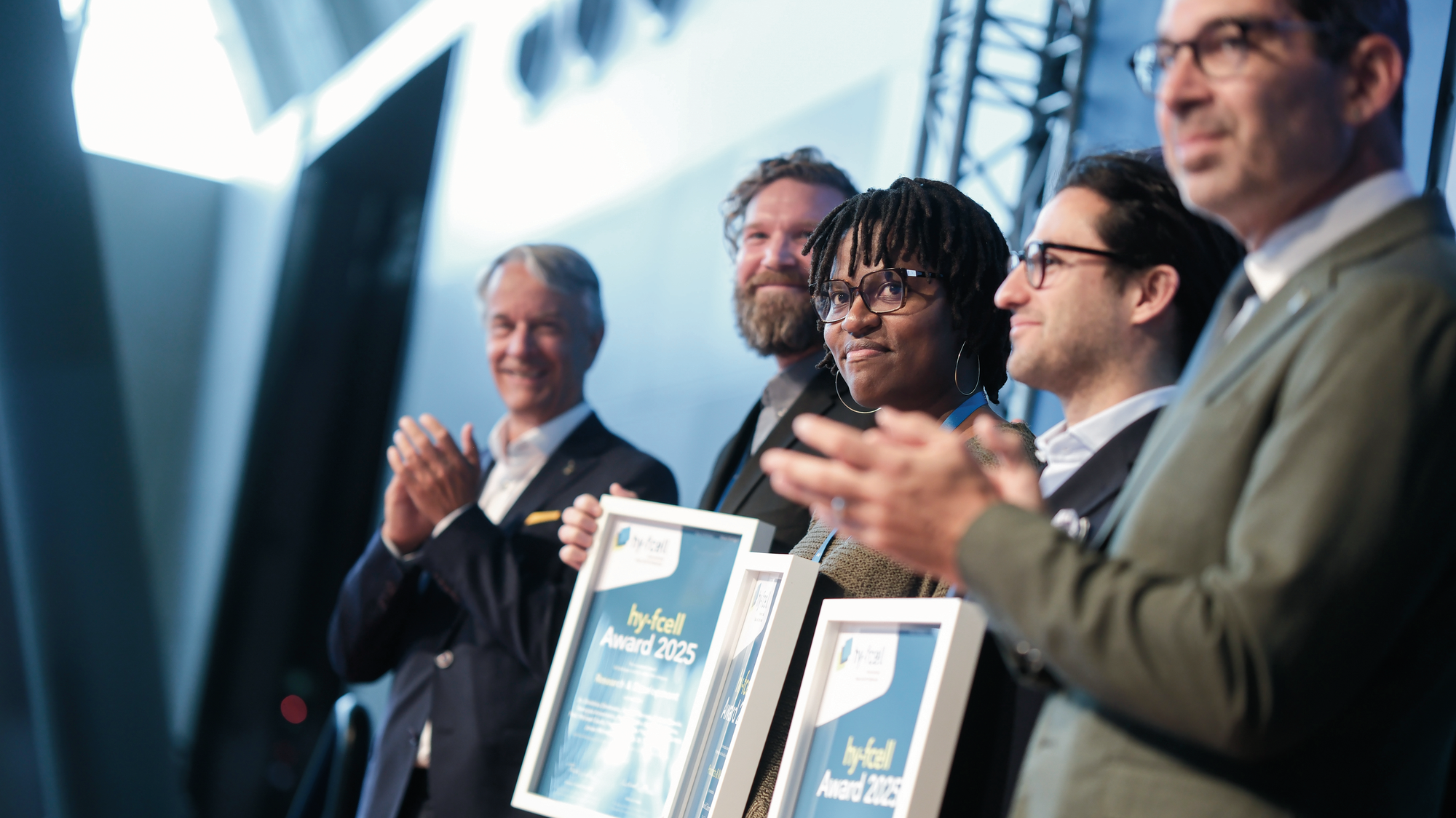 Award winners hold their certificates in their hands