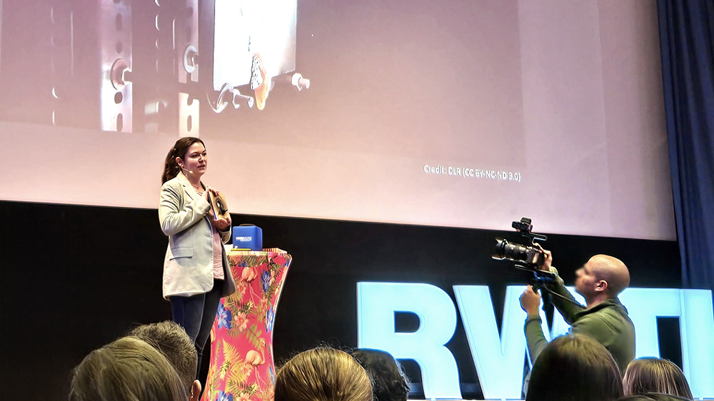 Anika Weber presents an exhibit that demonstrates how concentrated solar rays can penetrate a solid steel plate at over 1,000 degrees Celsius within a few seconds.