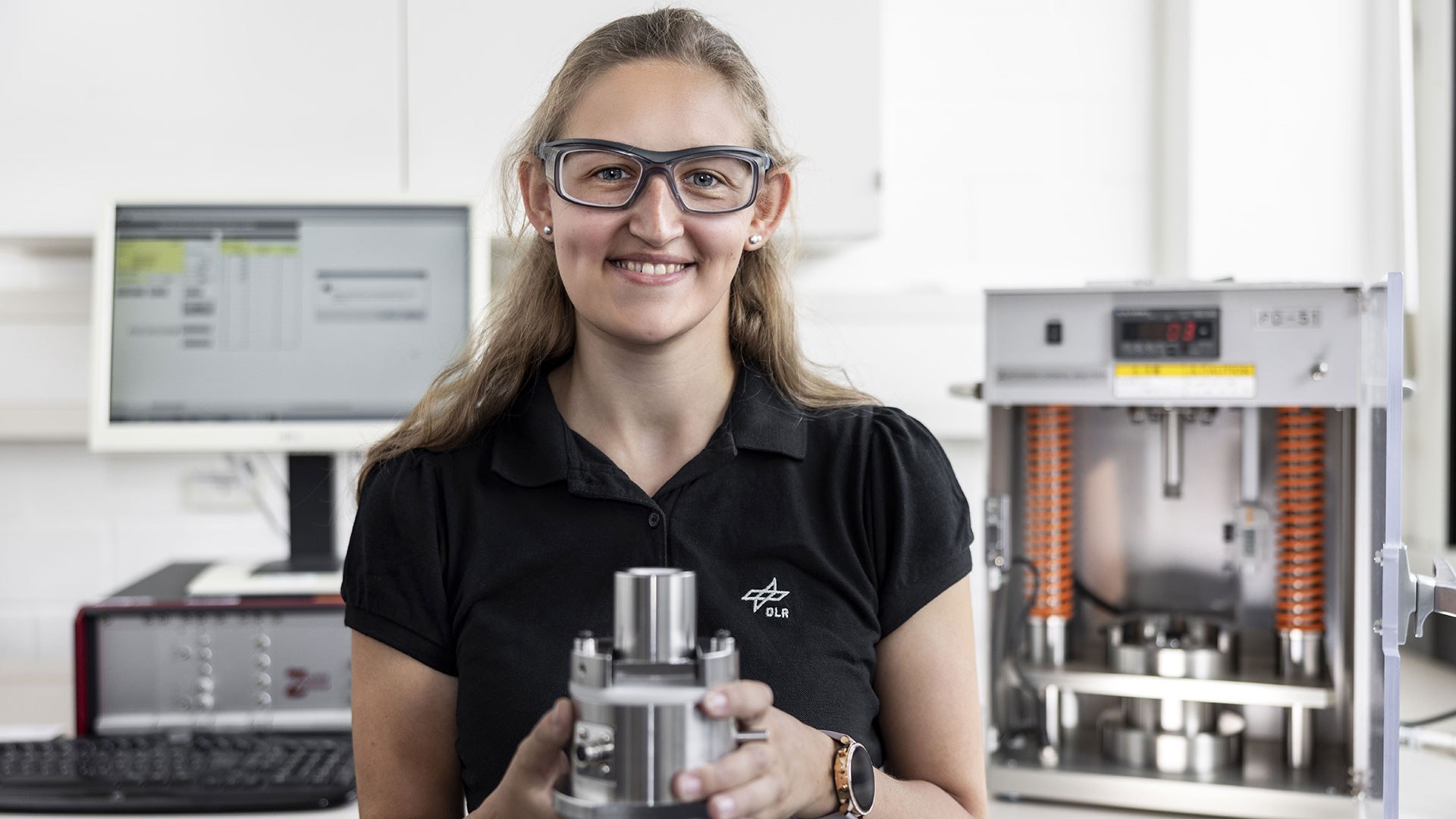 Employee measuring the electrical conductivity of powder samples in the laboratory