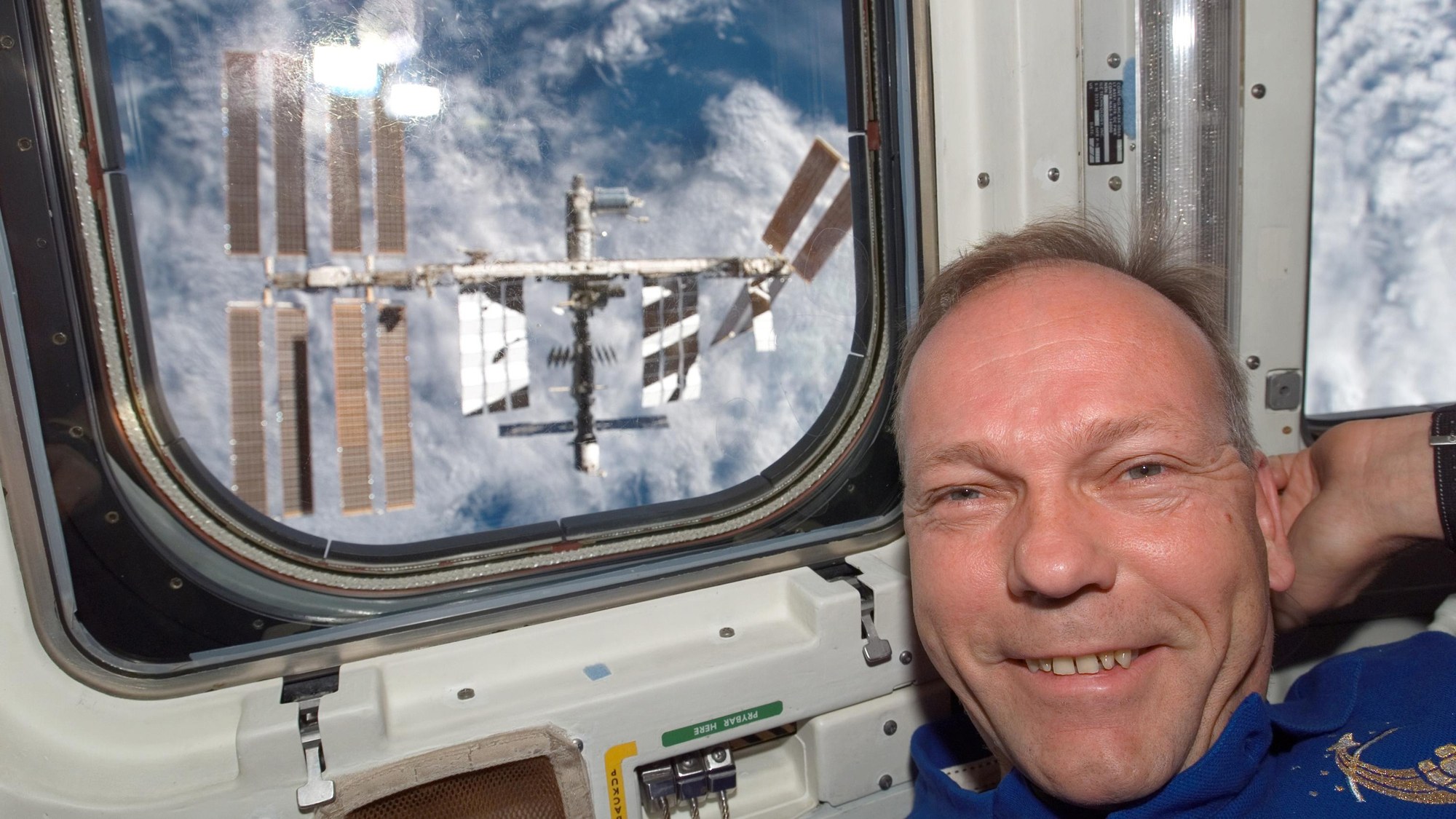 ESA astronaut Hans Schlegel in front of the Space Shuttle window