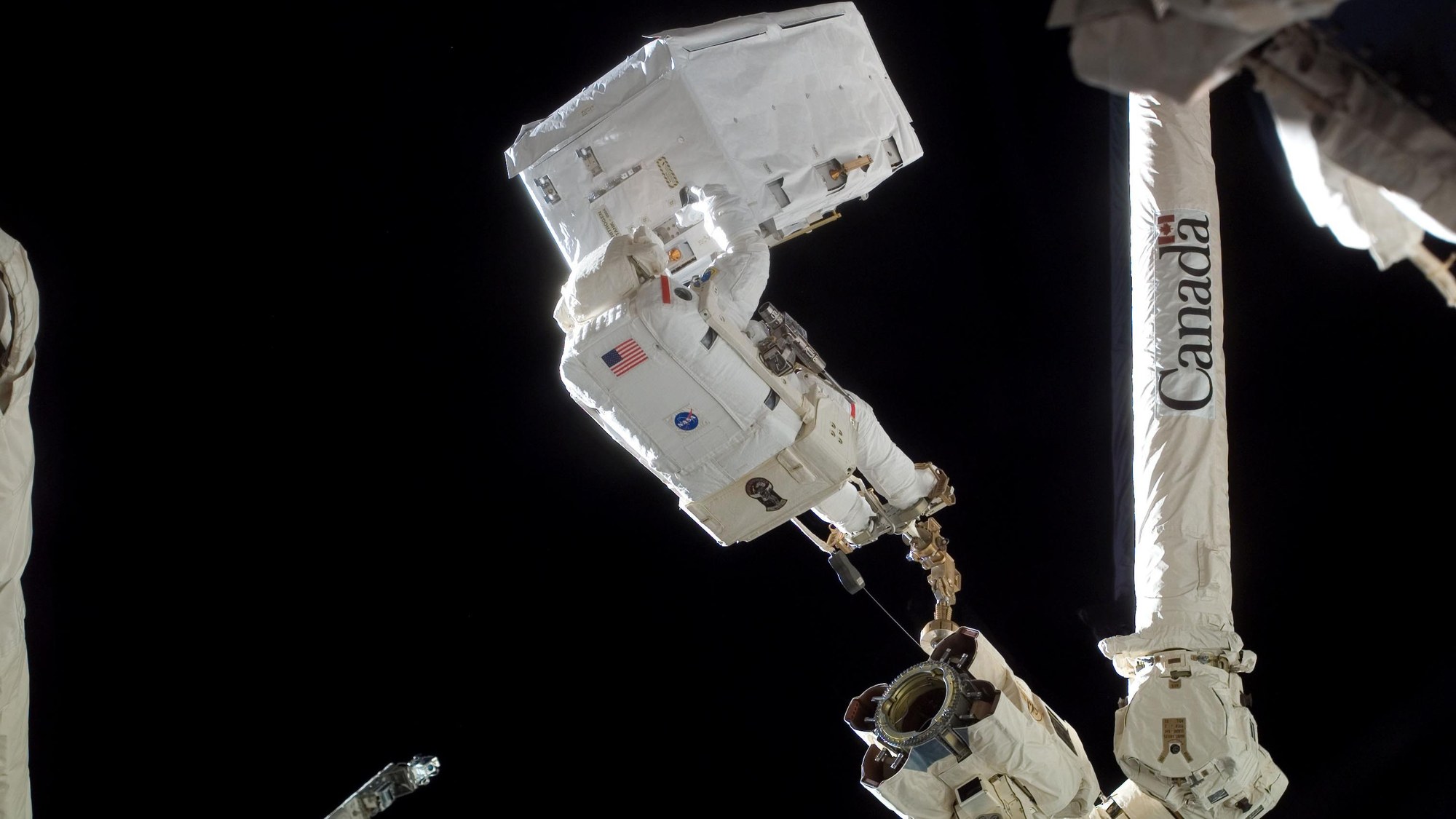 NASA astronaut Rex Walheim on the ISS robotic arm