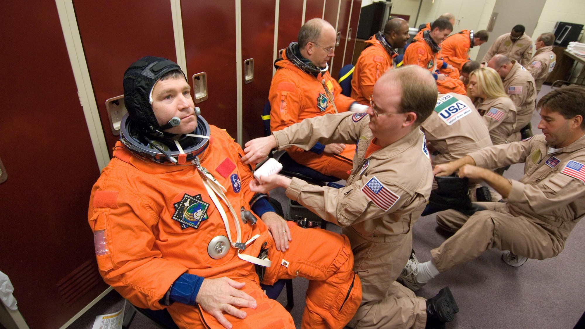 United Space Alliance (USA) suit technicians assisted the crew