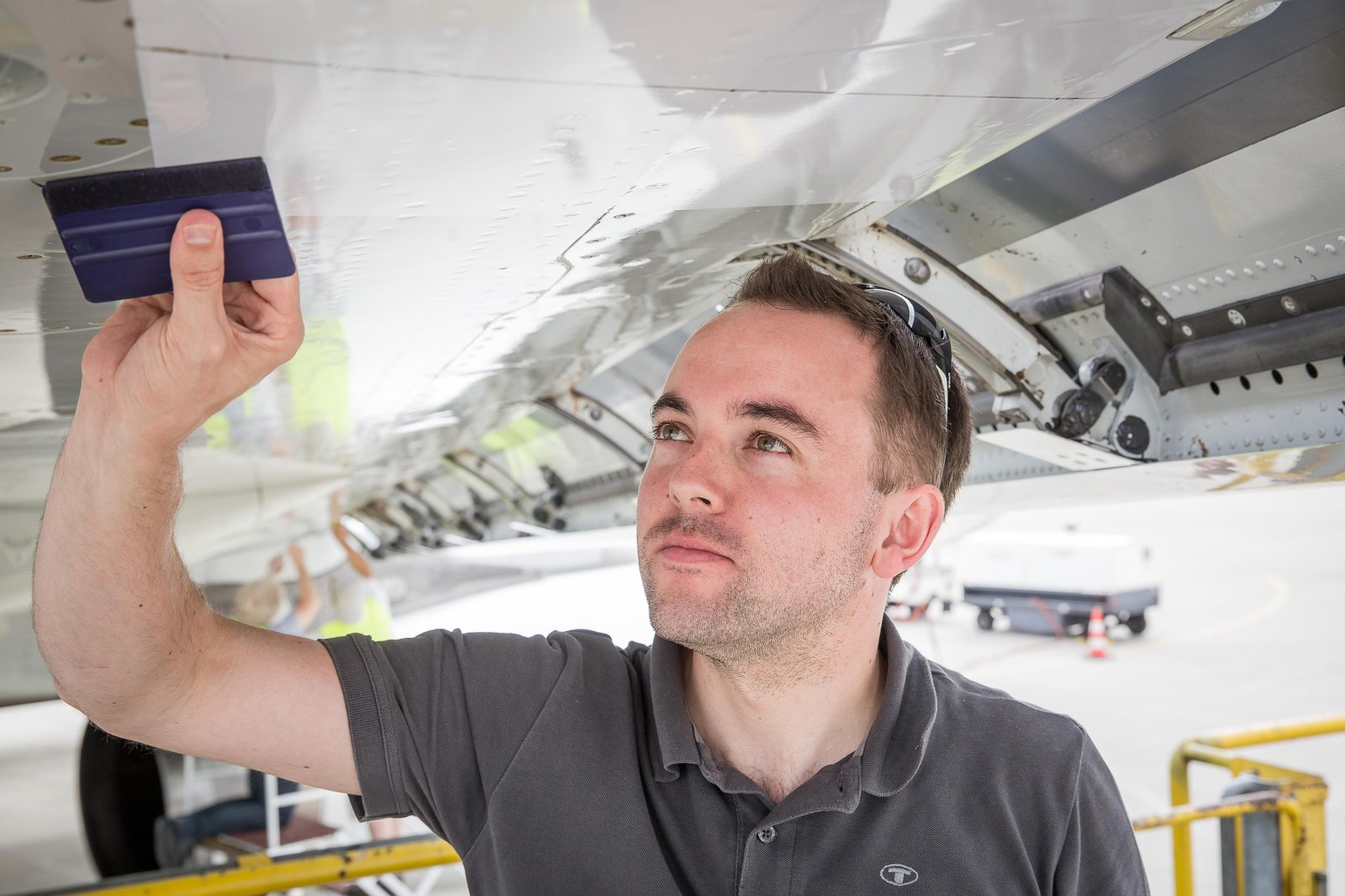 Putting adhesive foil behind the leading edge flaps on the wings