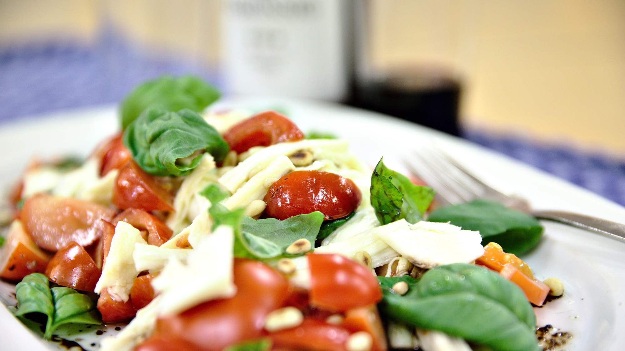 Caprese salad with tomatoes and basil from the greenhouse