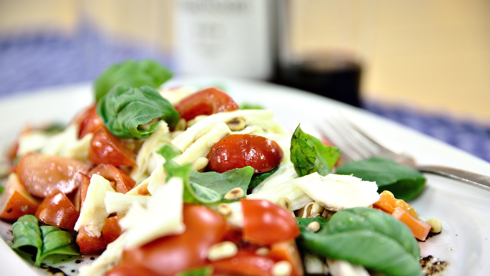 Caprese salad with tomatoes and basil from the greenhouse