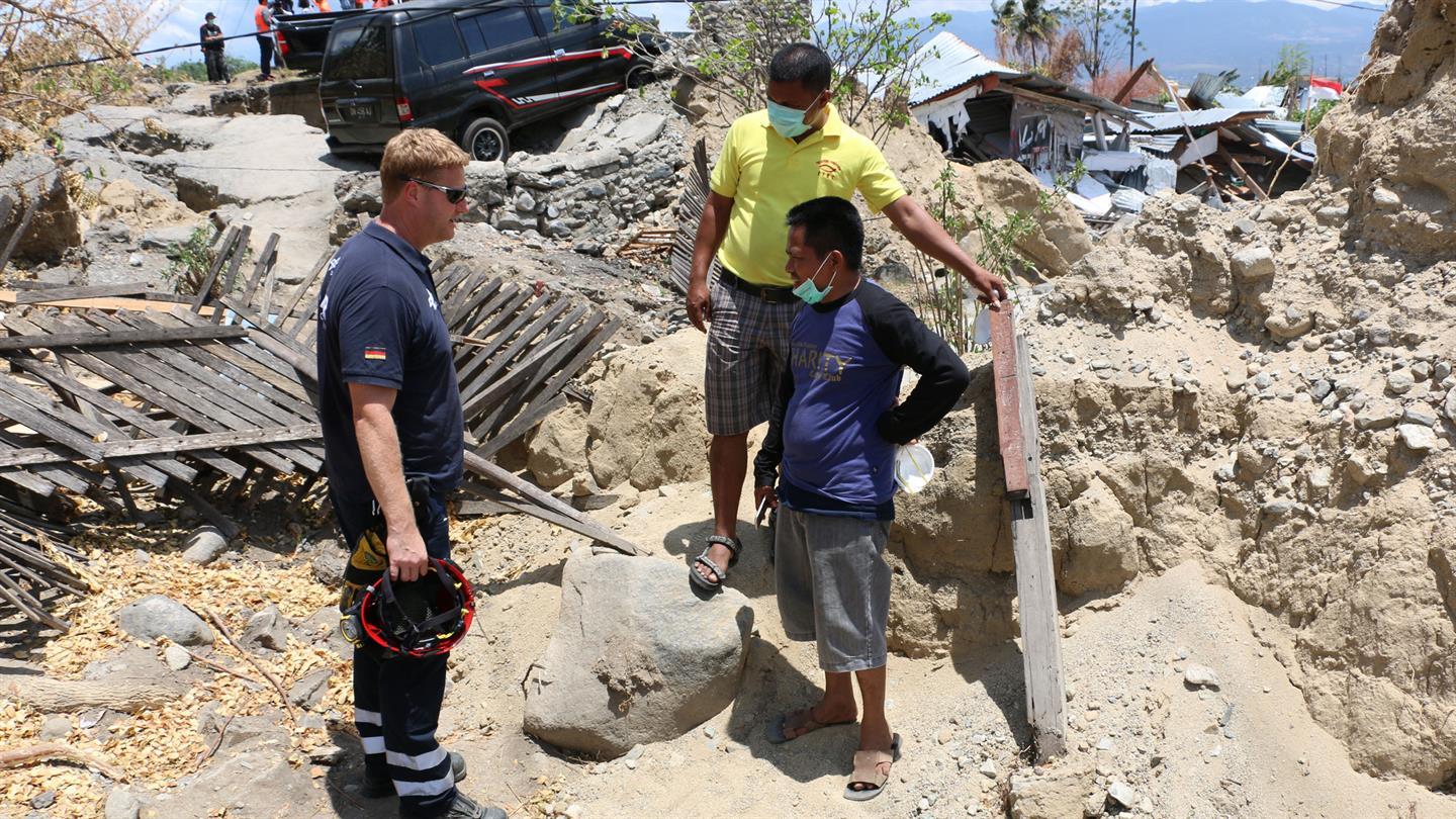 I.S.A.R. disaster relief worker talks to local people