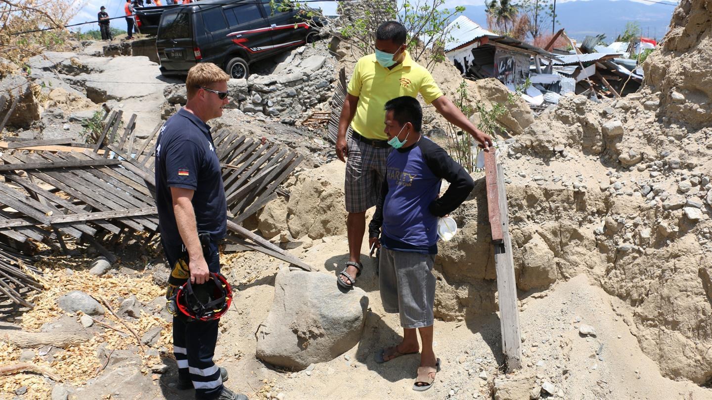 I.S.A.R. disaster relief worker talks to local people