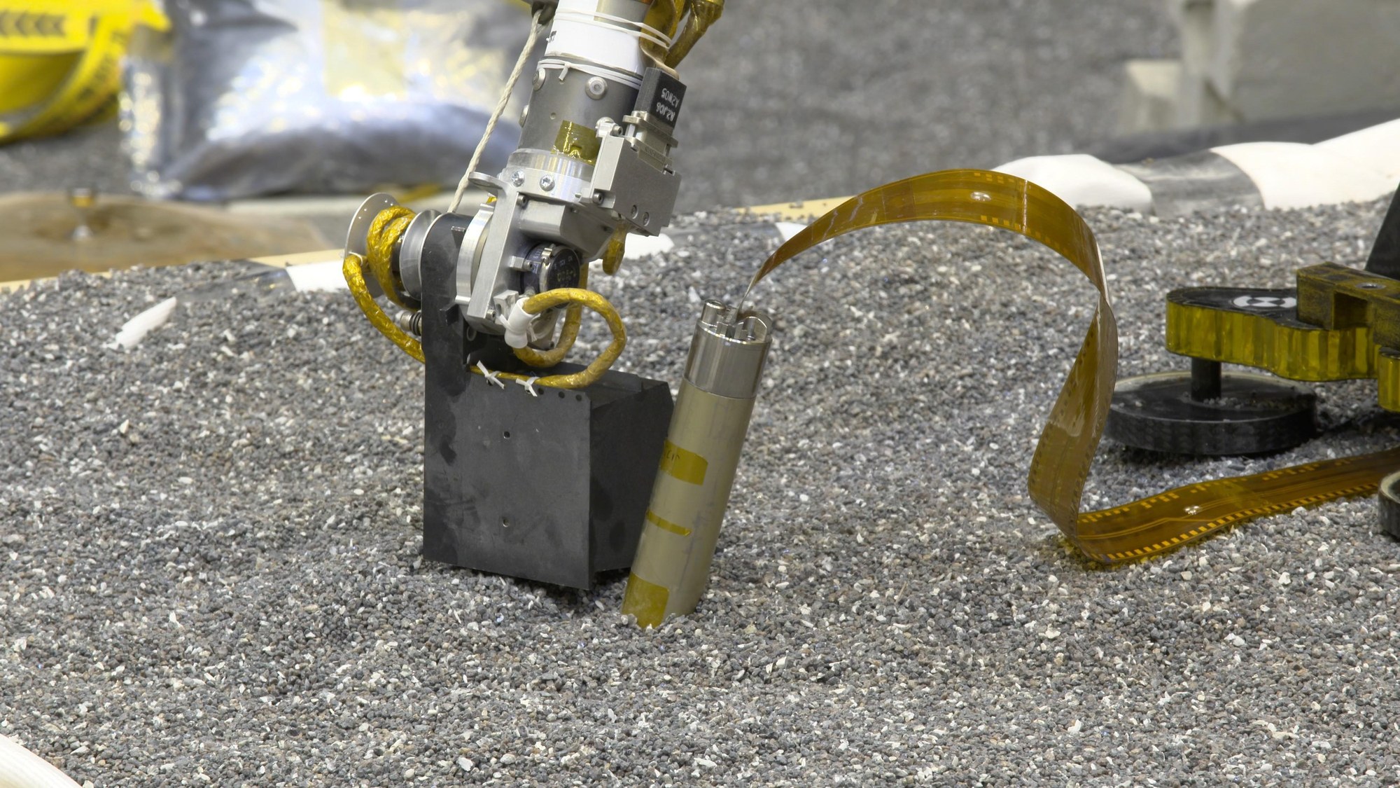 Testing the InSight arm, as it presses onto soil in the laboratory