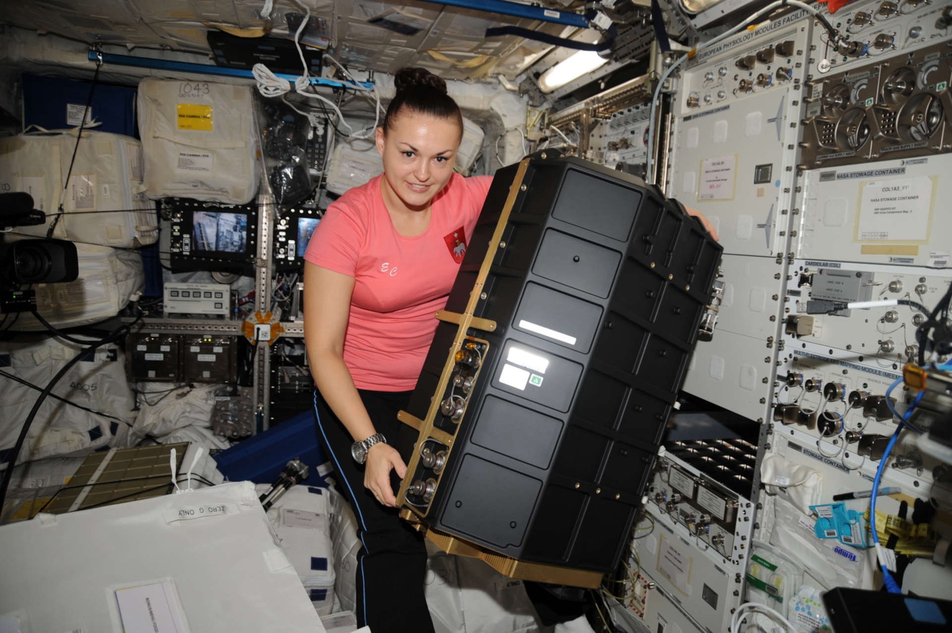 Cosmonaut Elena Serova installing the third laboratory, 'PK-4', in the European Columbus module on the ISS