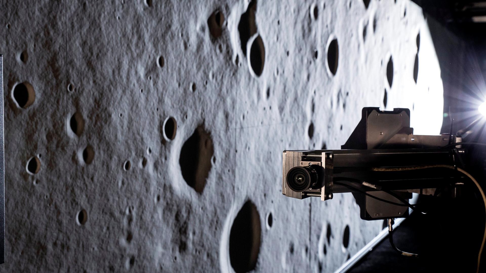 Terrain model for simulating lunar landing approach, next to a robot with camera