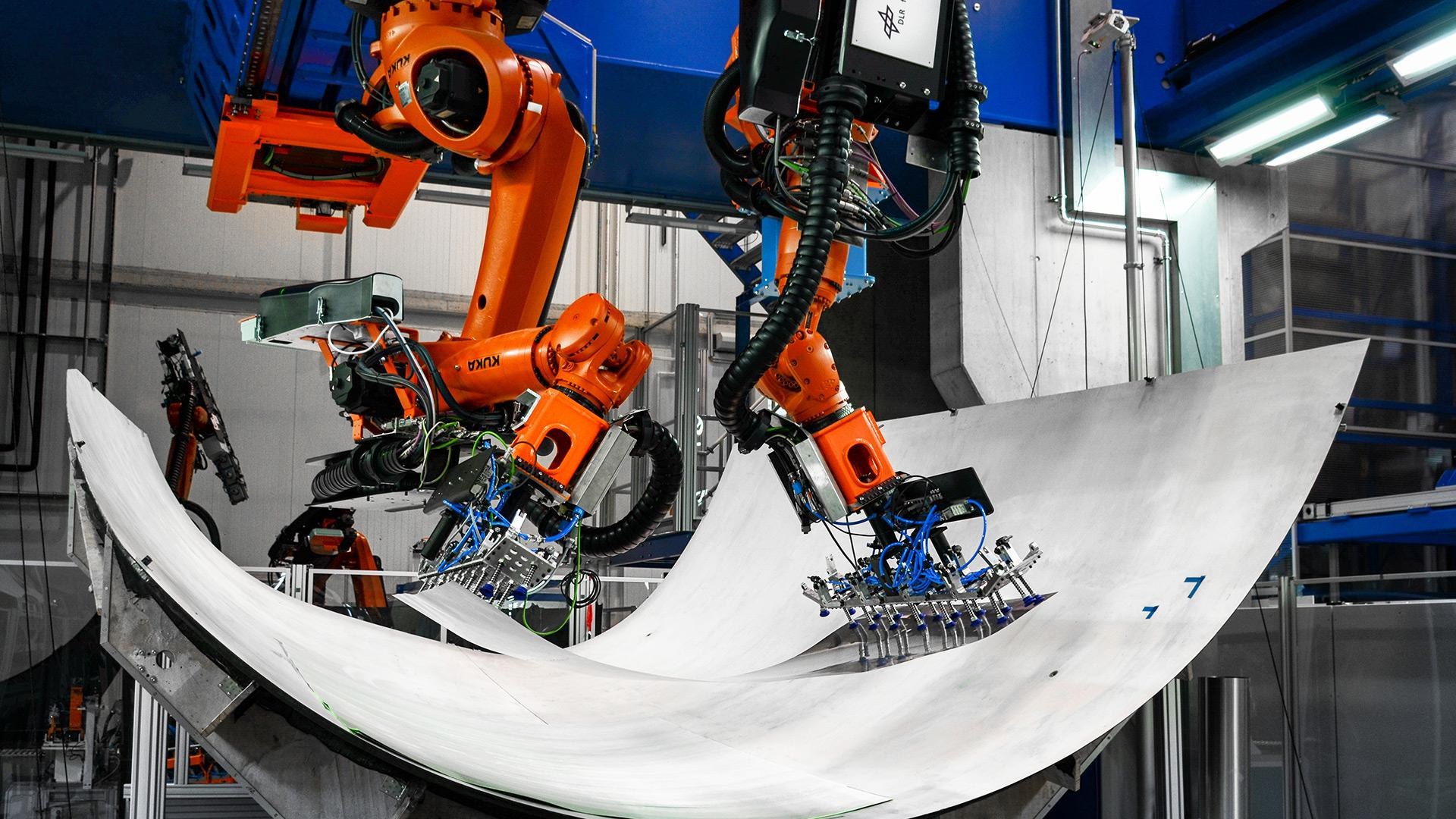 Automated handling of materials via cooperating robots