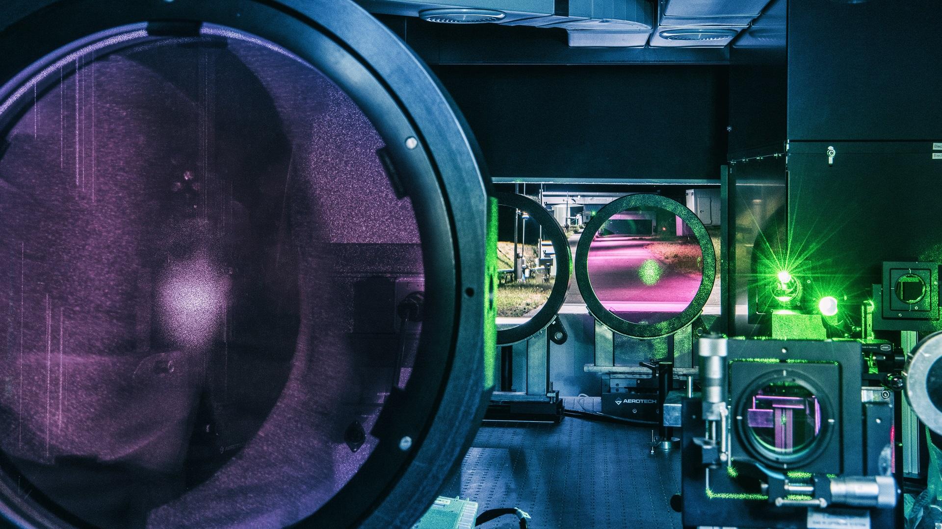View from the transmitting station along the laser beam propagation in the open beam path, with the receiving station in the background