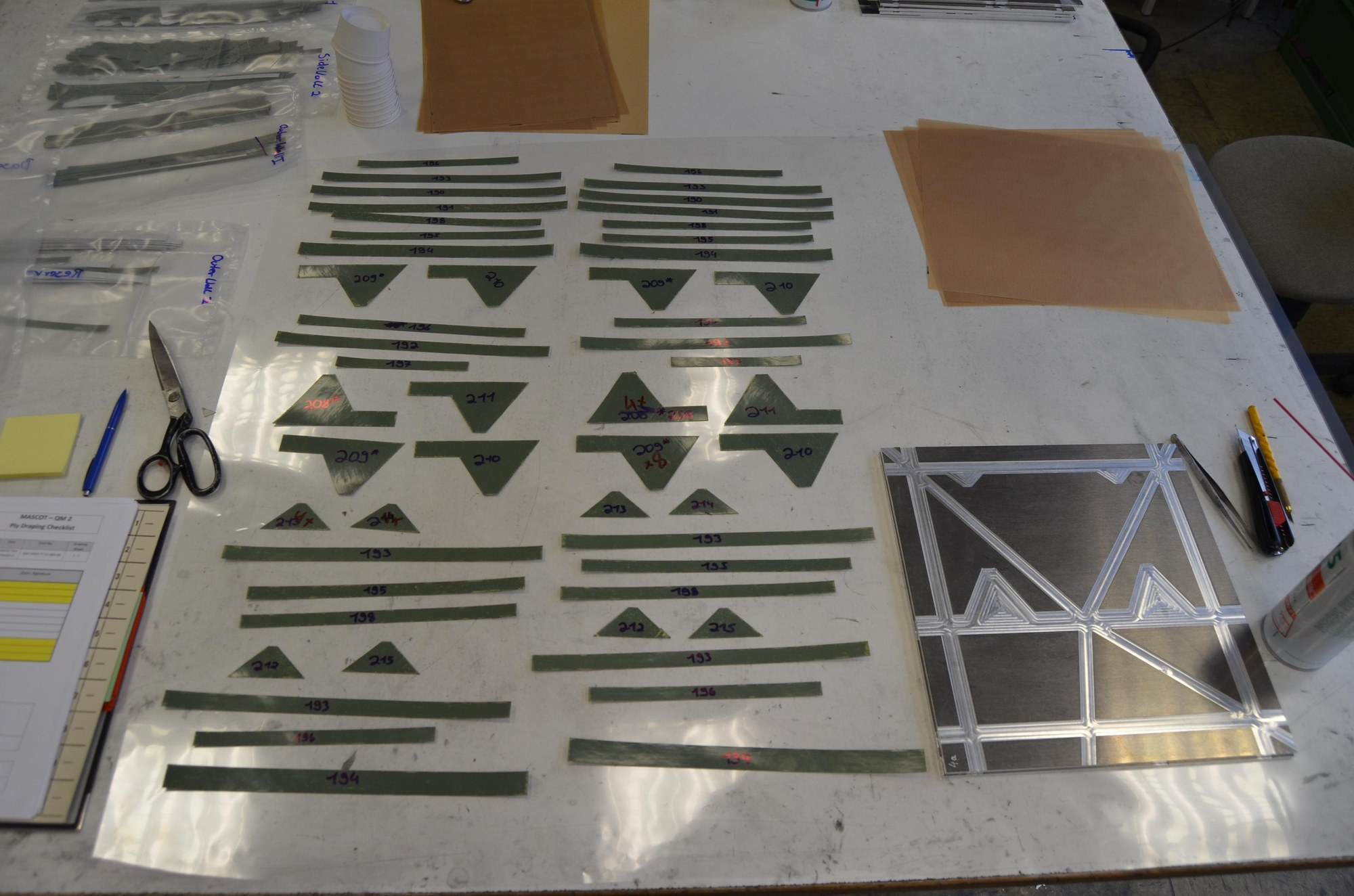 Machine-cut semi-finished parts made of CFRP fibre composite plastic for making the surface layers for one of the side walls of the MASCOT lander.