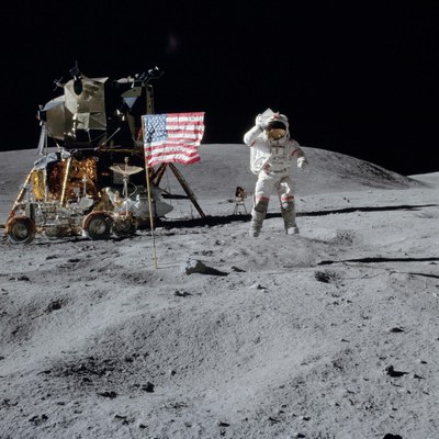 John Young jumps and salutes the US flag
