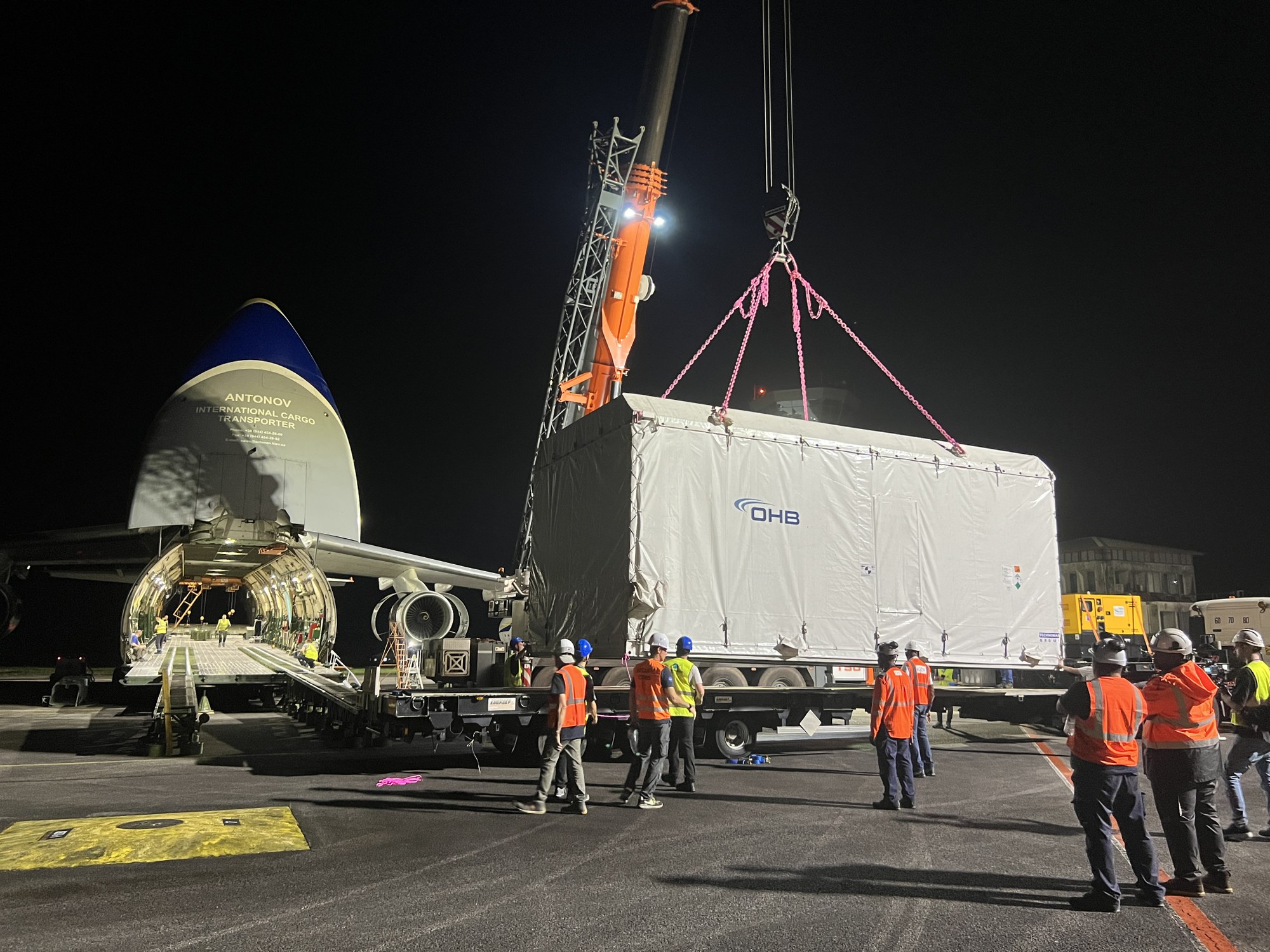 Heinrich Hertz satellite in transport box on crane.