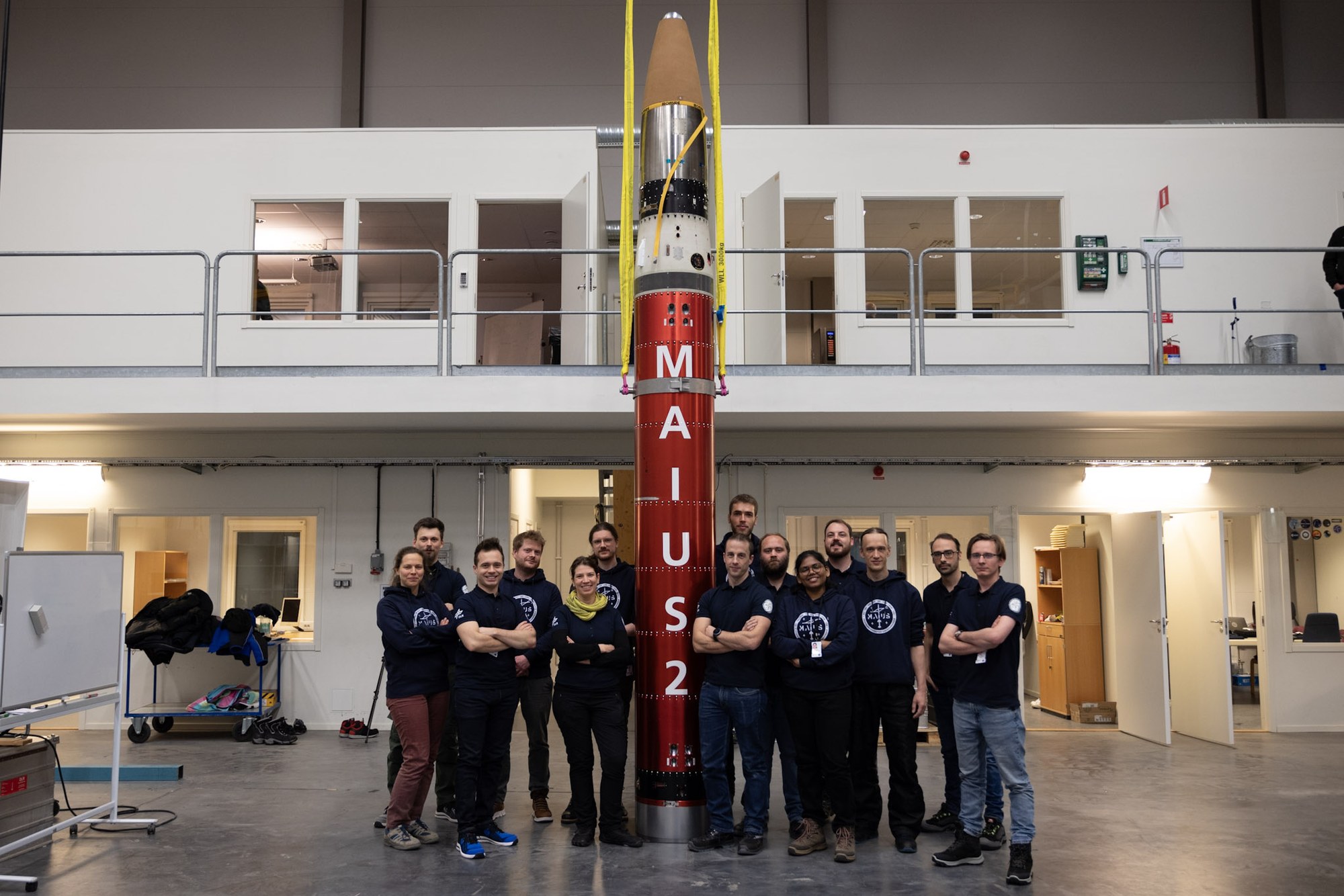 MAIUS-2 team stand before their rocket