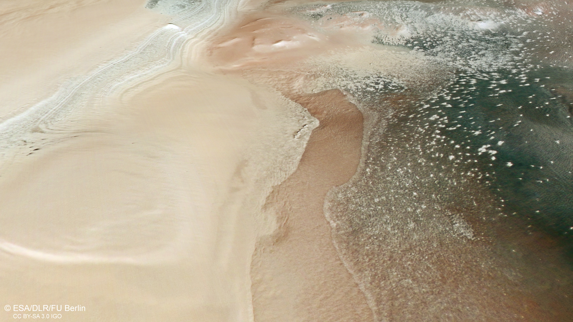 Perspective view from the east on the transition from layered deposits to exposures of patterned soil