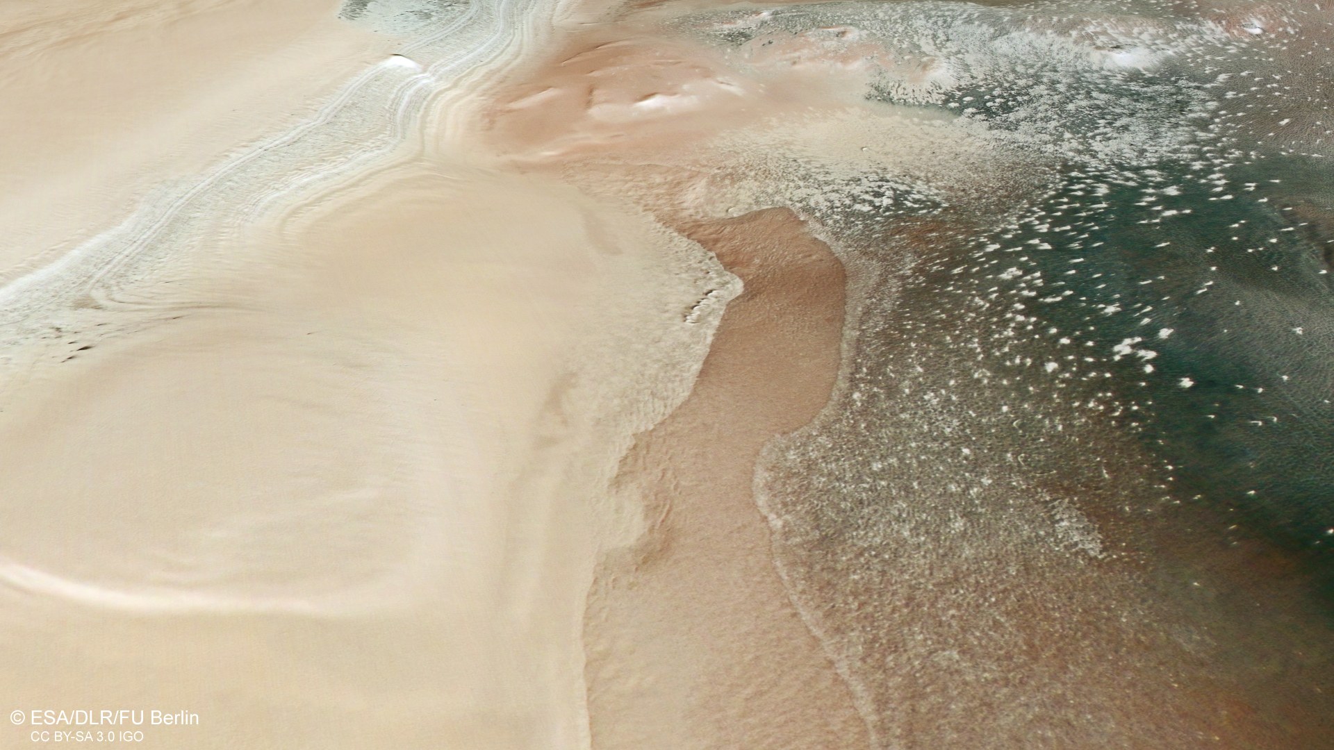 Perspective view from the east on the transition from layered deposits to exposures of patterned soil