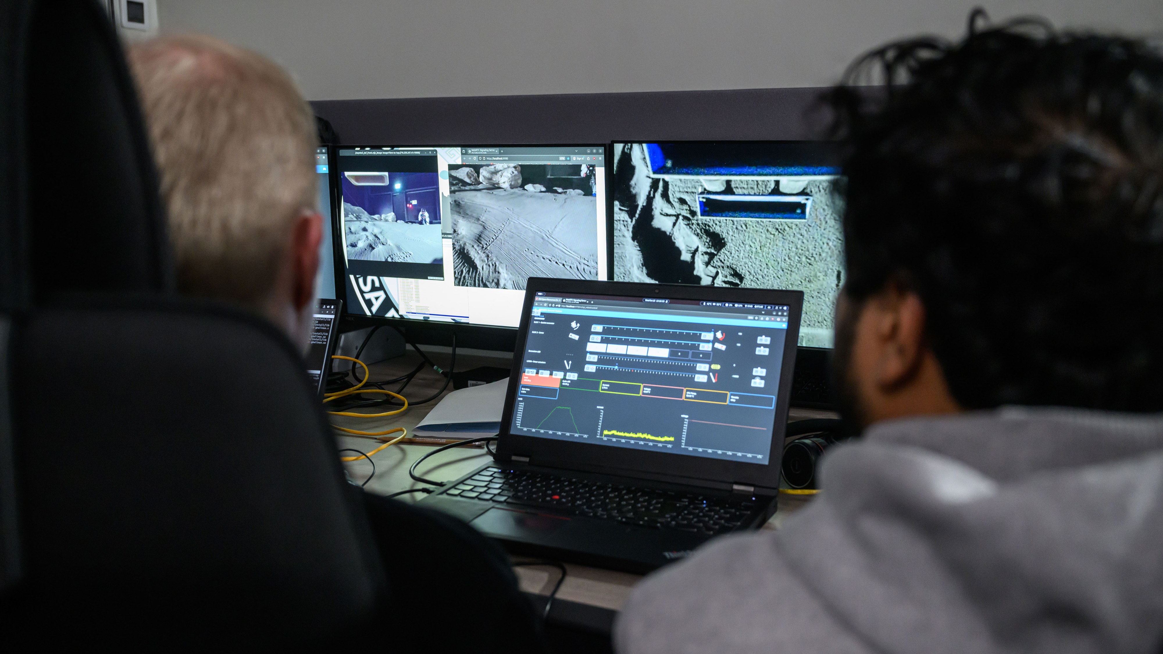 Team members monitor the test from the LUNA hall control room