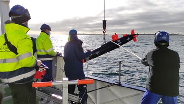 Deploying the Autonomous Underwater Vehicle from the ship deck by crane. The AUV can also be slipped from the shore.