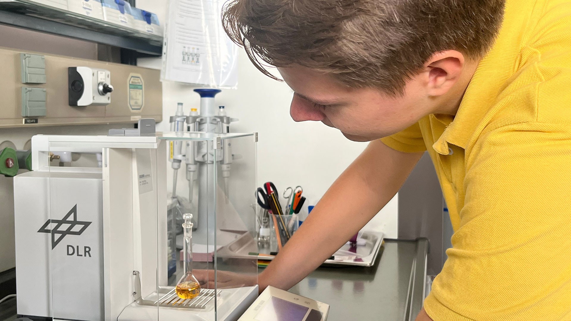 A student working on a device in a laboratory