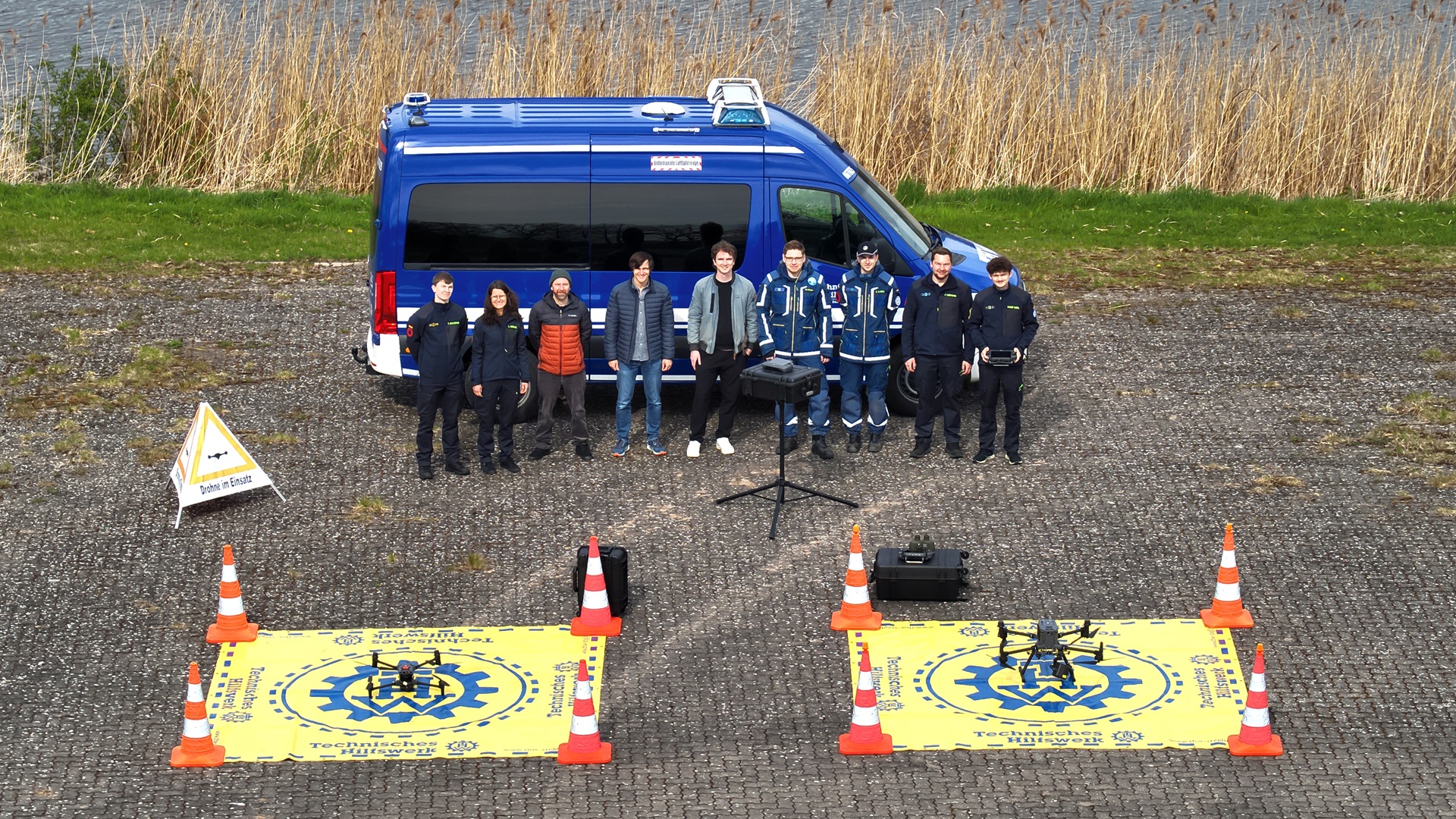 Group photo of ADRET team with drones and emergency vehicle